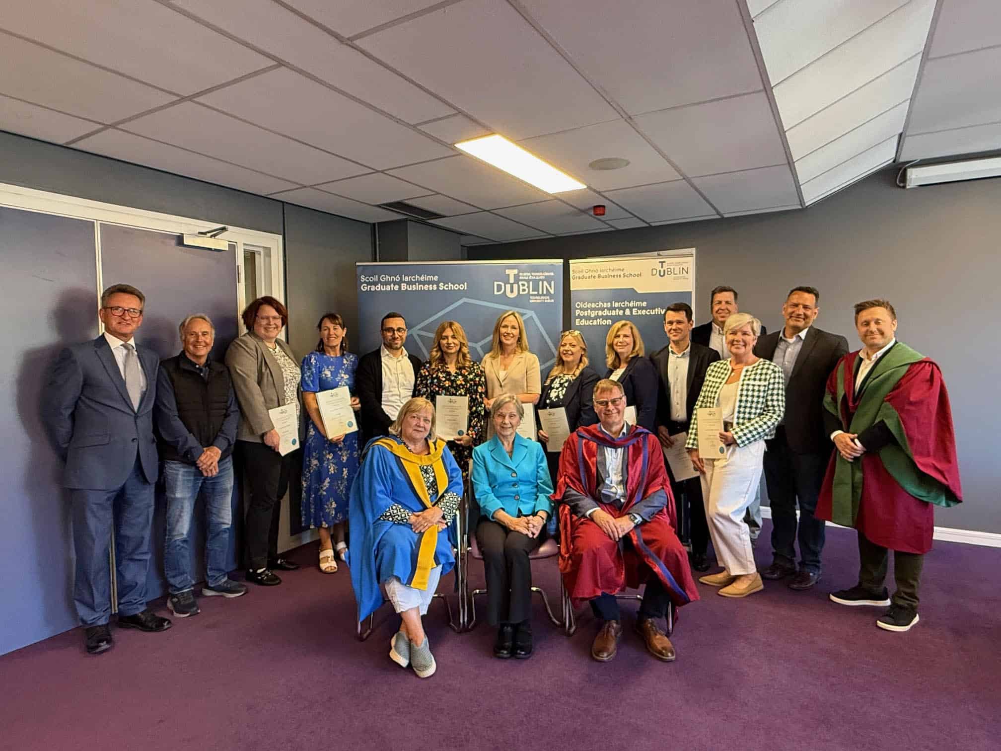 Group photo of QBL graduates with certificates.